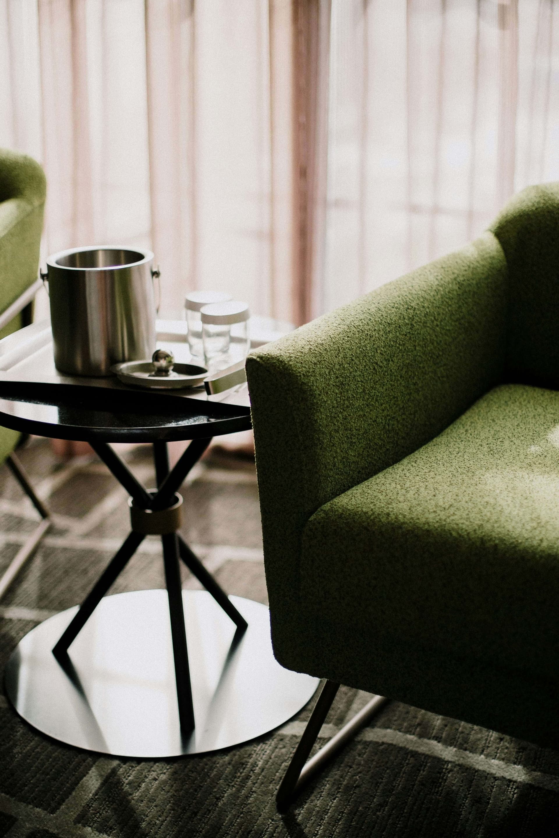 Green lounge chair beside a small table