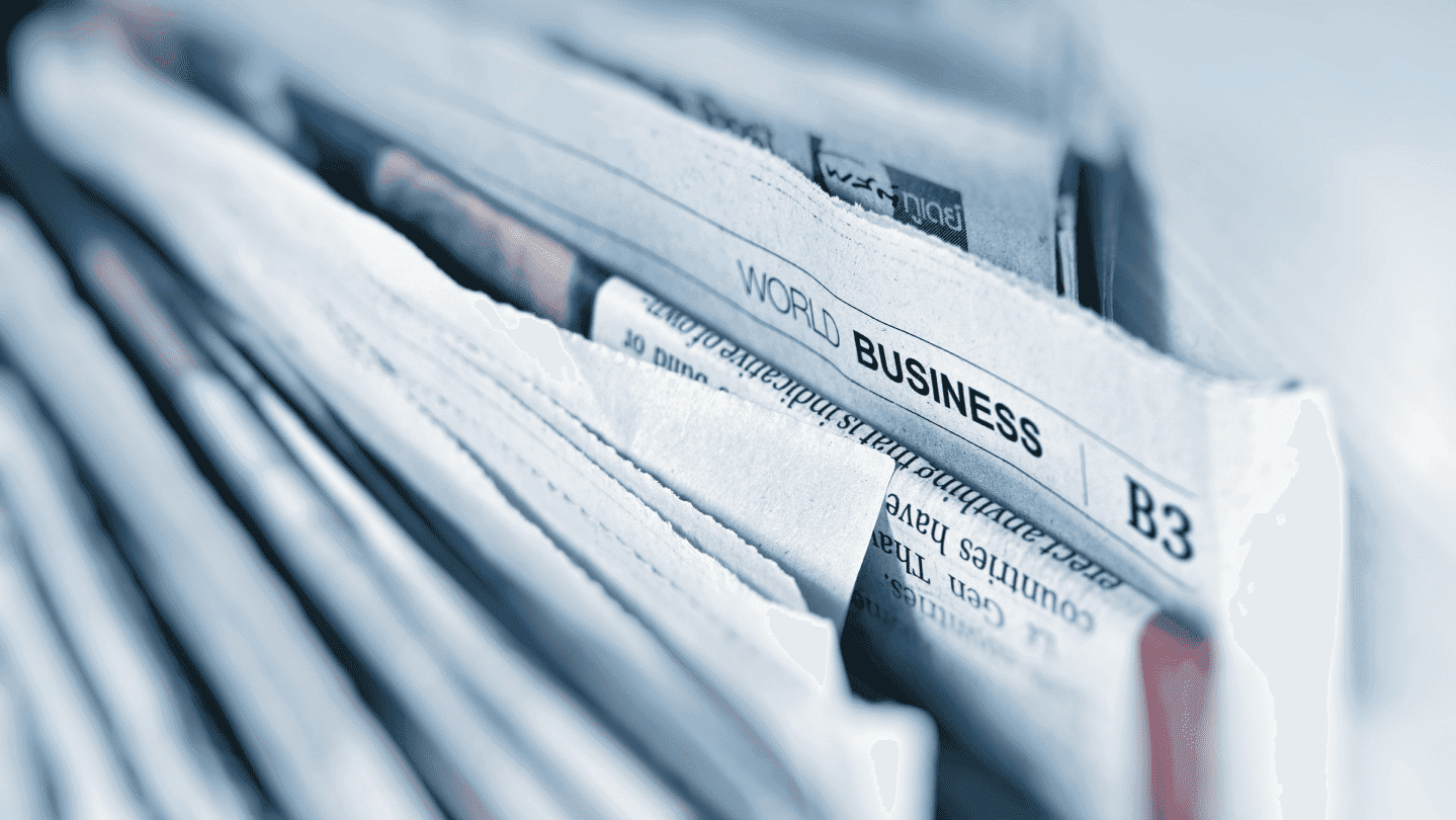Newspapers with a business section headline