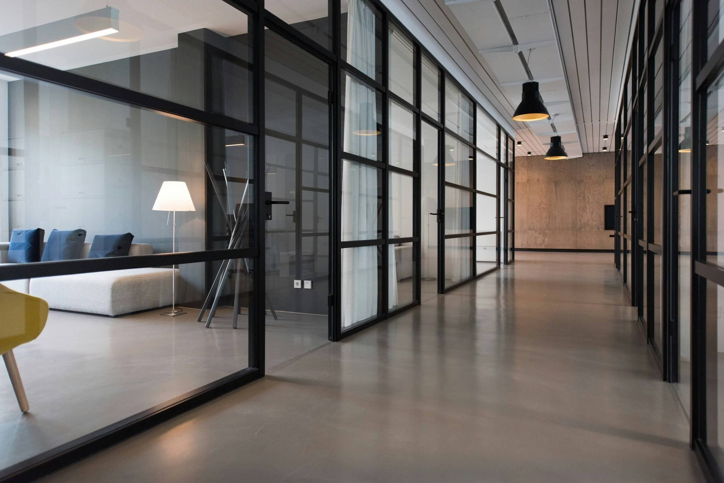 Modern office corridor with glass meeting rooms